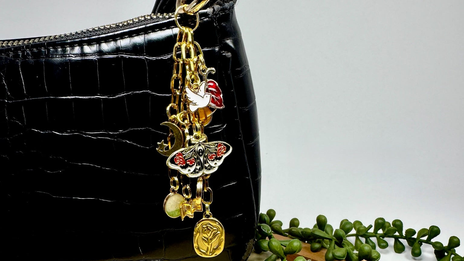 Gold purse charm with multiple charms for style
