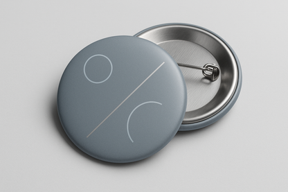 pin back button that is neutral and cool in color and design